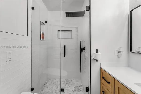 a bathroom with a shower and a sink
