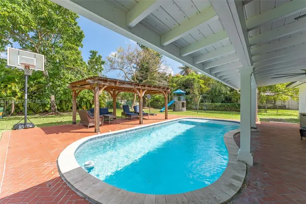 a view of a swimming pool with an outdoor seating
