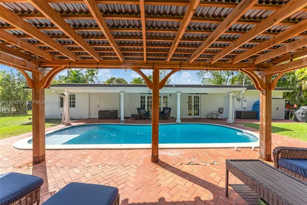 a view of a house with backyard porch and sitting area