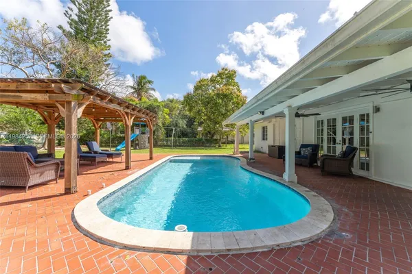 a view of swimming pool with seating space