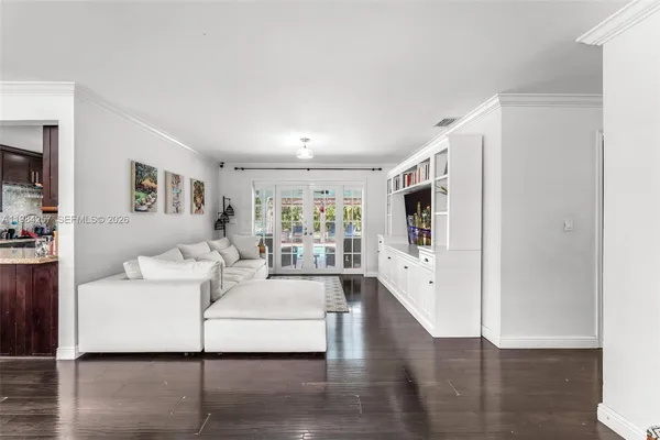 a living room with furniture wooden floor and a flat screen tv
