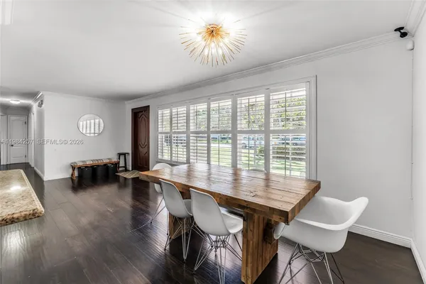 a view of a dining room with furniture and a large window
