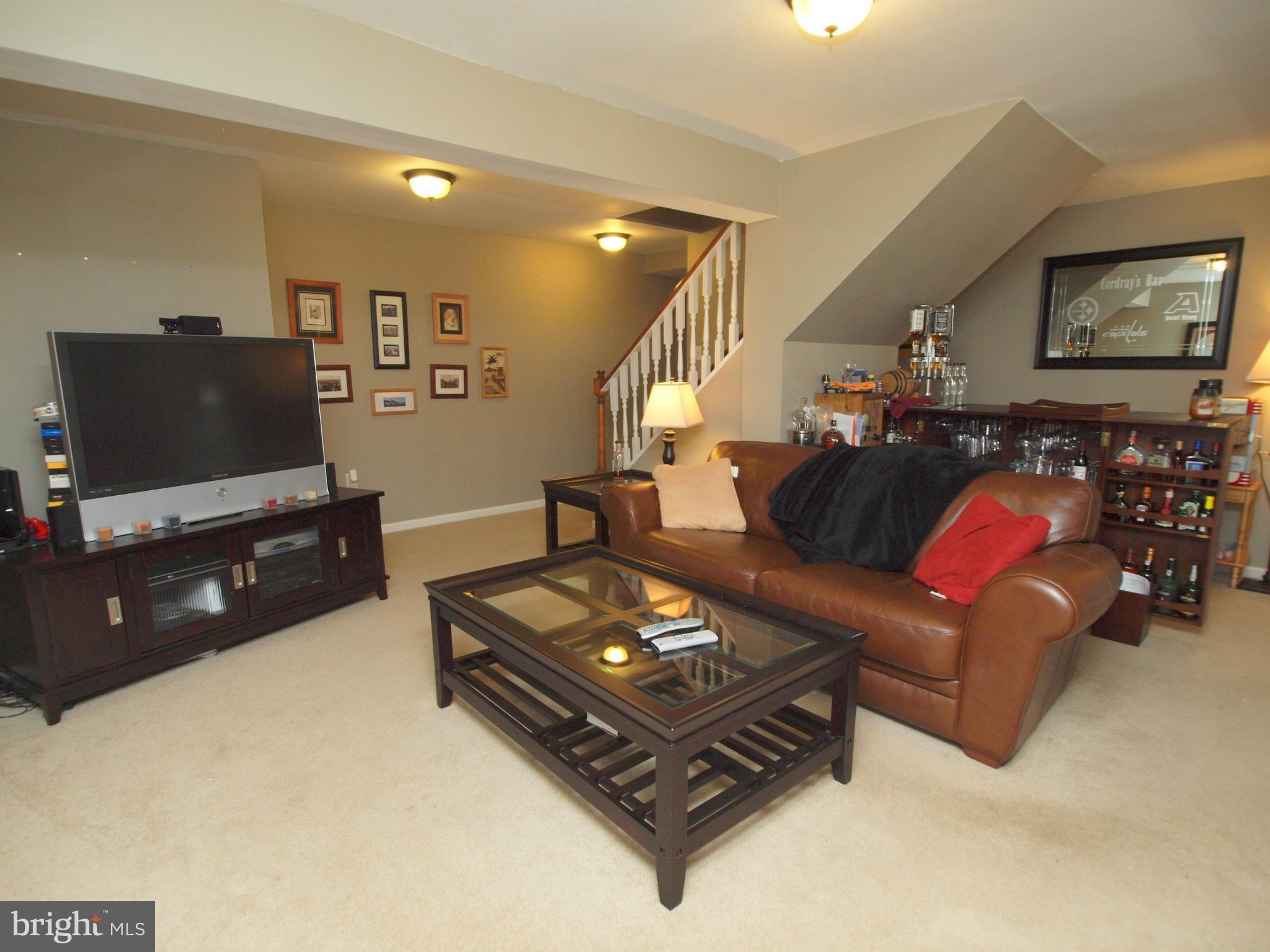 6823 Spring Beauty Court Springfield, VA 22152 - Photo 20 of 29 a living room with furniture and a flat screen tv