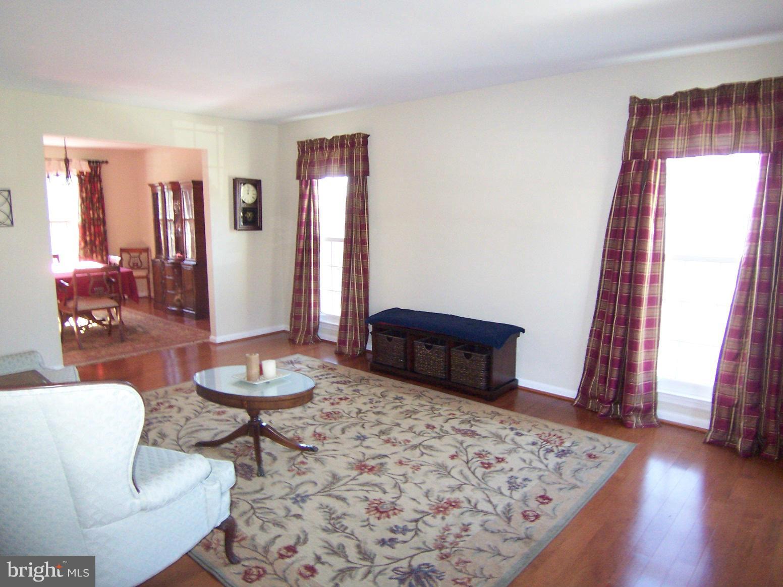 6823 Spring Beauty Court Springfield, VA 22152 - Photo 5 of 29 a living room with furniture and a rug