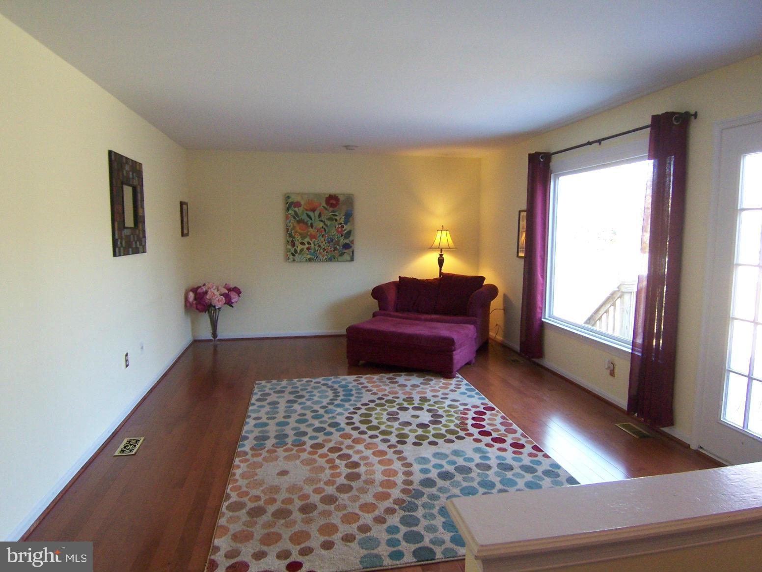 6823 Spring Beauty Court Springfield, VA 22152 - Photo 7 of 29 a living room with a couch and a bookshelf