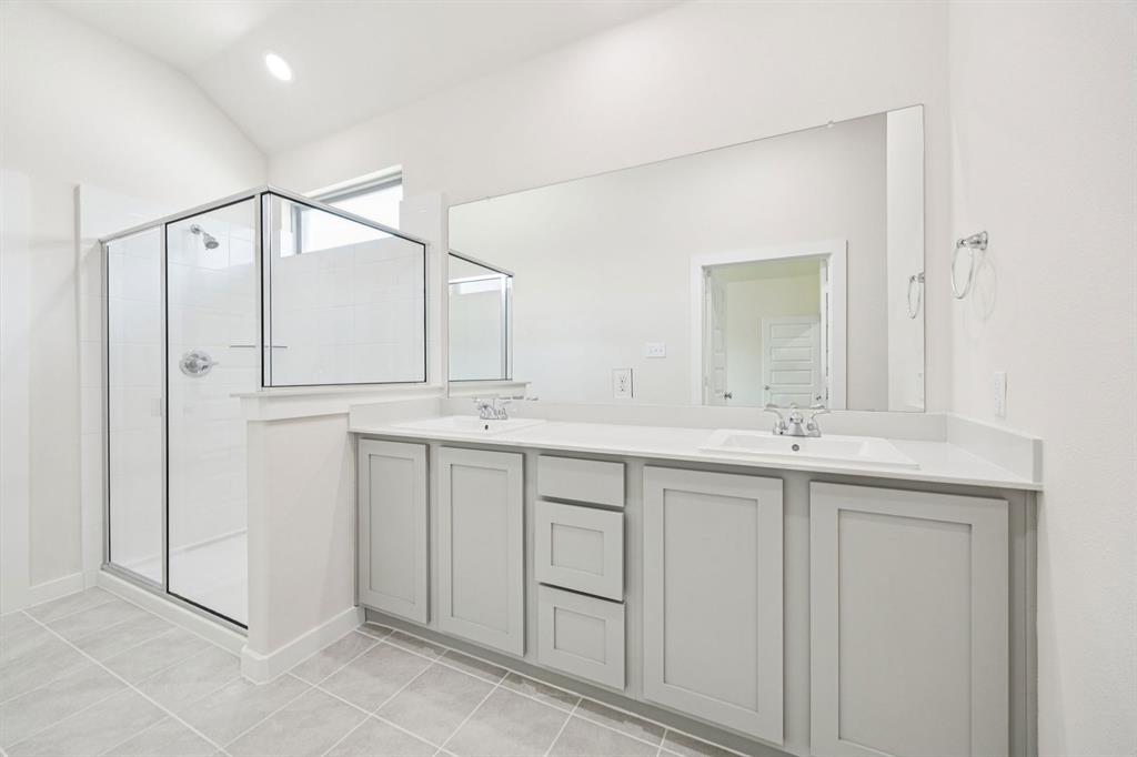 1127 Sunward Road Princeton, TX 75407 - Photo 16 of 29 a bathroom with a double vanity sink and mirror