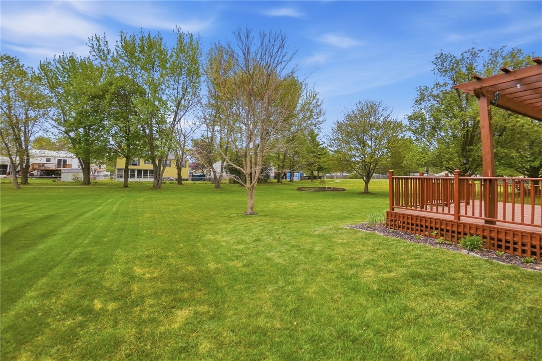 135 Concord Farm Road Englewood, OH 45322 - Photo 44 of 46 Expansive green space and a wooden deck for outdoor enjoyment and relaxation.