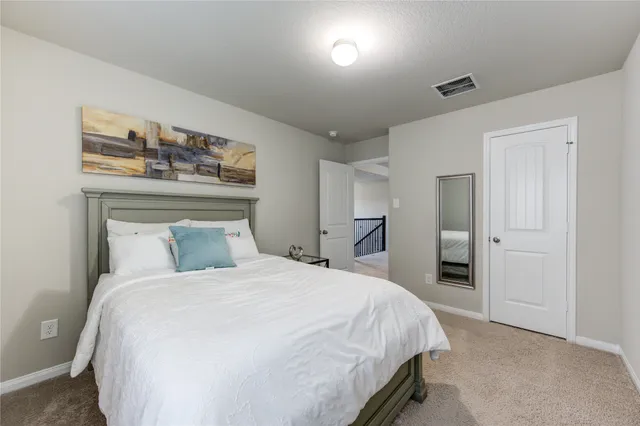 a bedroom with a bed and a night stand