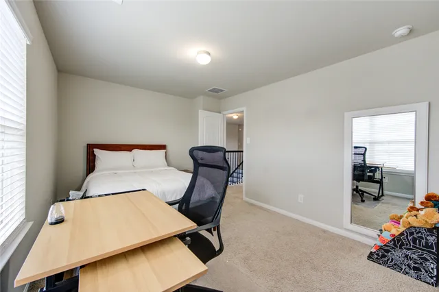 a bedroom with furniture and a window