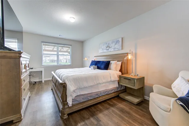 a bed room with a bed and a chair