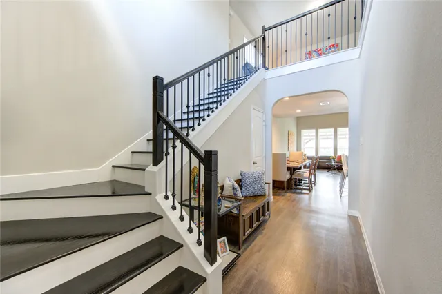 a view of entryway and hall with wooden floor