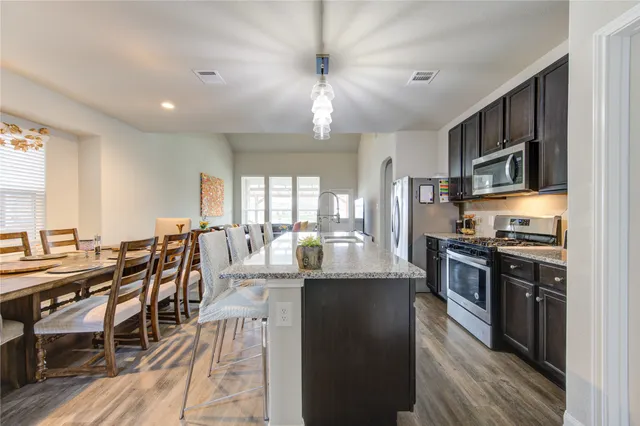 a kitchen with lots of counter top space and stainless steel appliances