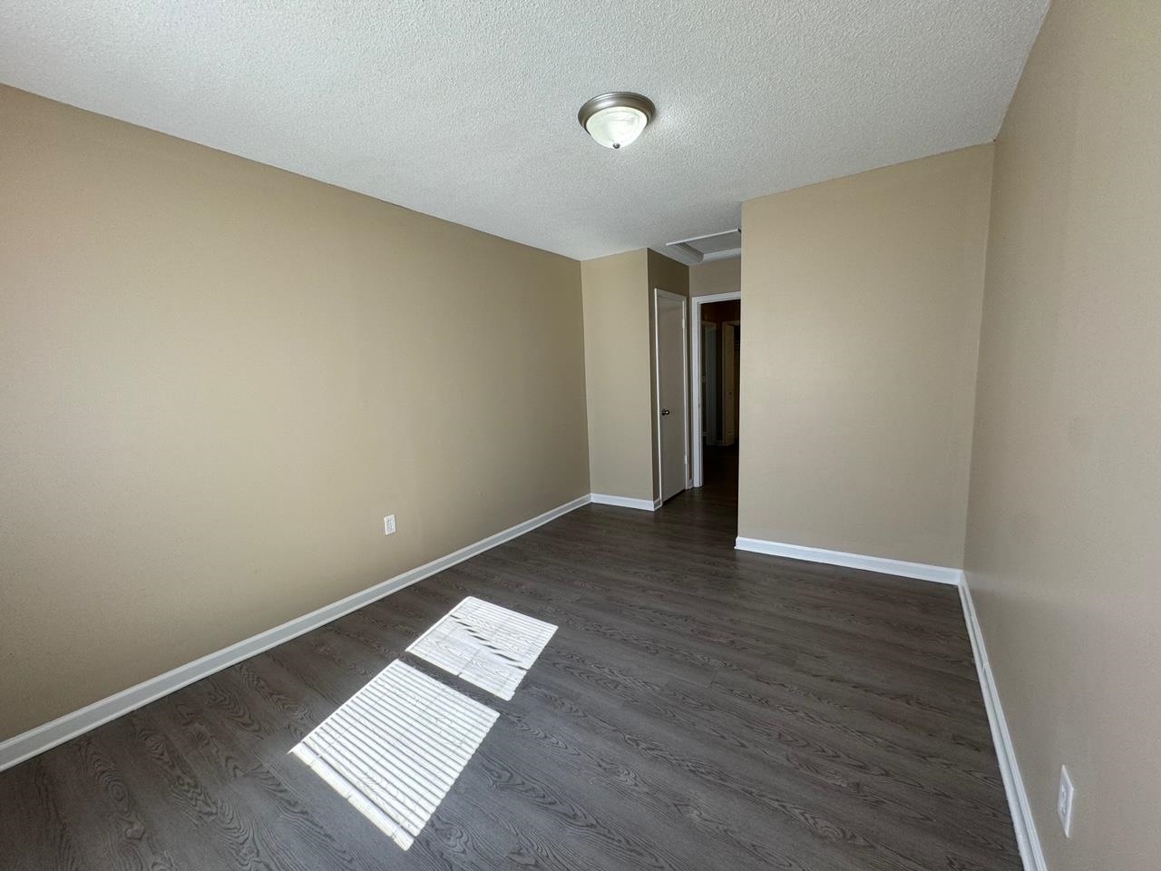 243 West Brooks Road Memphis, TN 38109 - Photo 12 of 19 an empty room with wooden floor