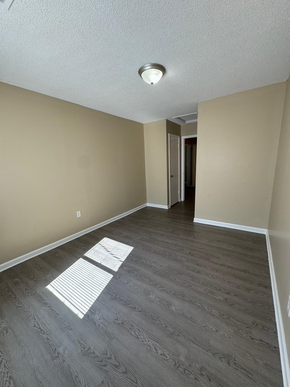 243 West Brooks Road Memphis, TN 38109 - Photo 13 of 19 a view of an empty room with wooden floor