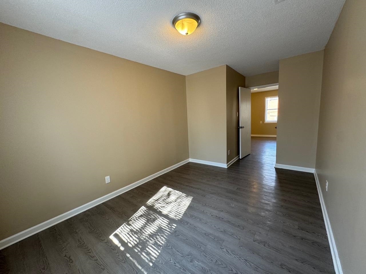 243 West Brooks Road Memphis, TN 38109 - Photo 15 of 19 an empty room with wooden floor and windows