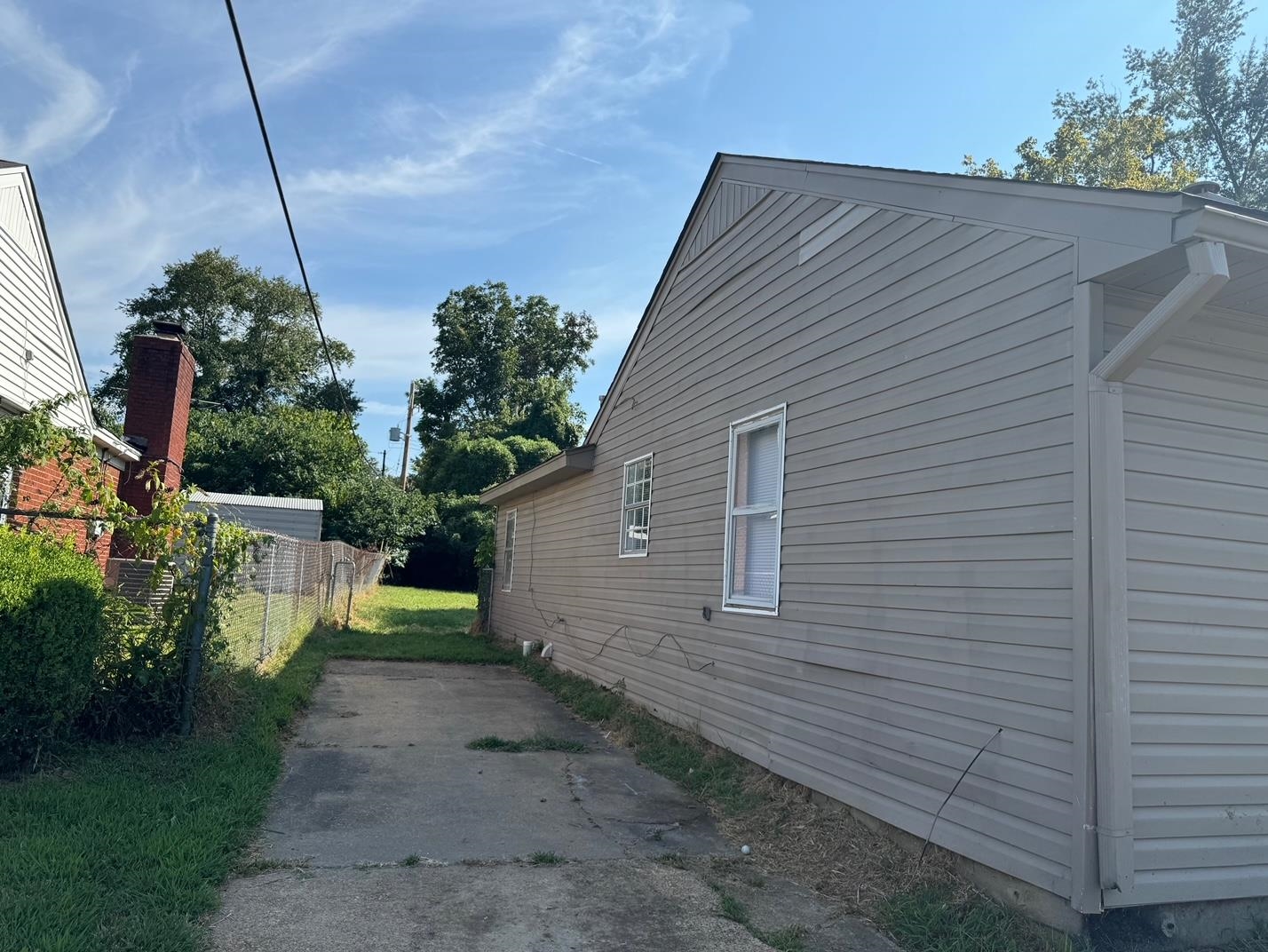243 West Brooks Road Memphis, TN 38109 - Photo 2 of 19 a view of a house with a backyard and plants