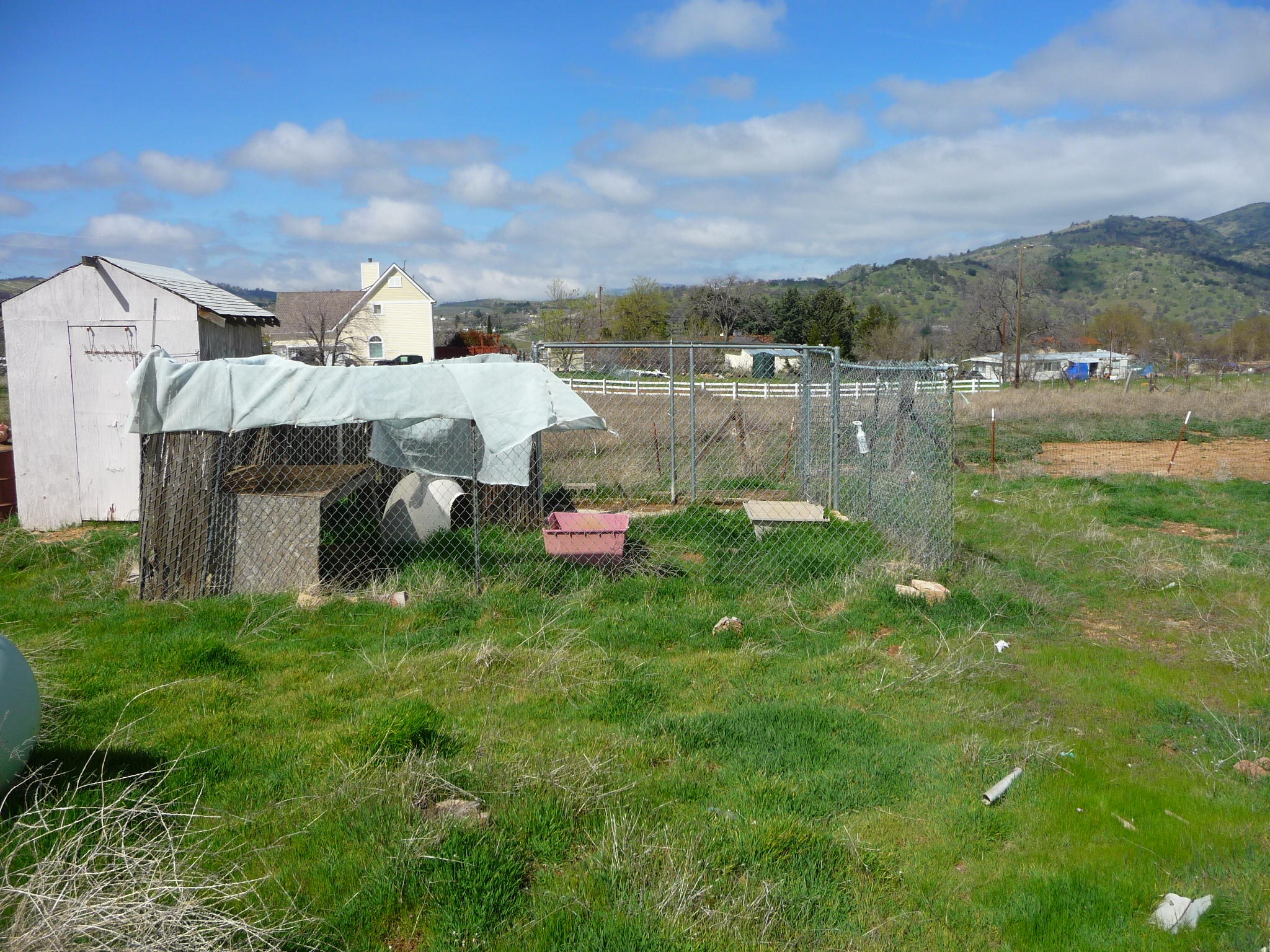 20825 Highline Road Tehachapi, CA 93561 - Photo 7 of 19 a view of a lake with a house in the background