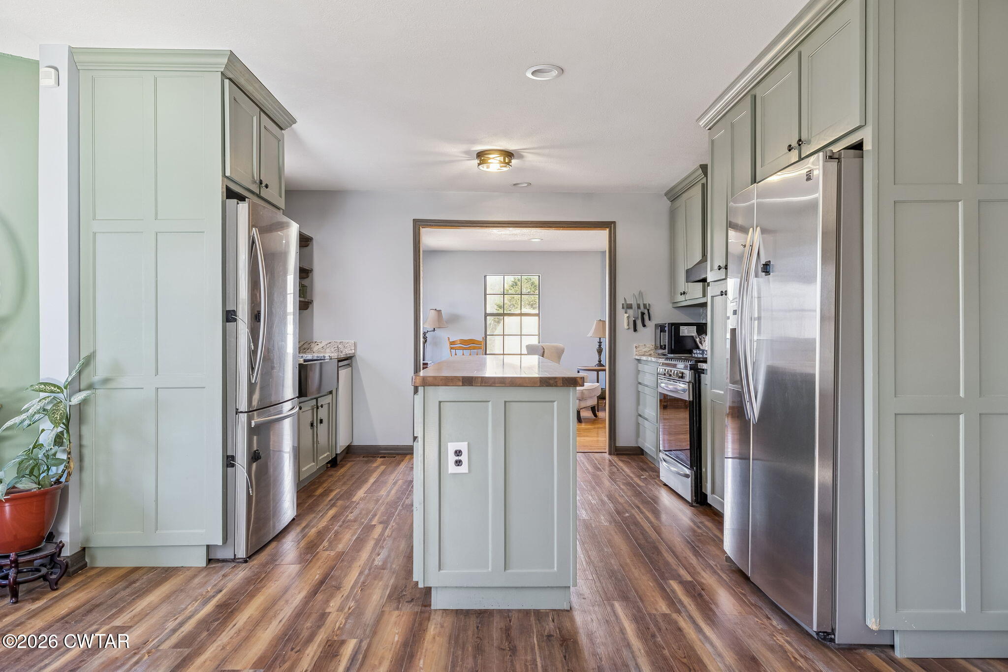 485 Lower Roans Creek Road Linden, TN 37096 - Photo 13 of 54 a kitchen with kitchen island wooden floor center island and stainless steel appliances