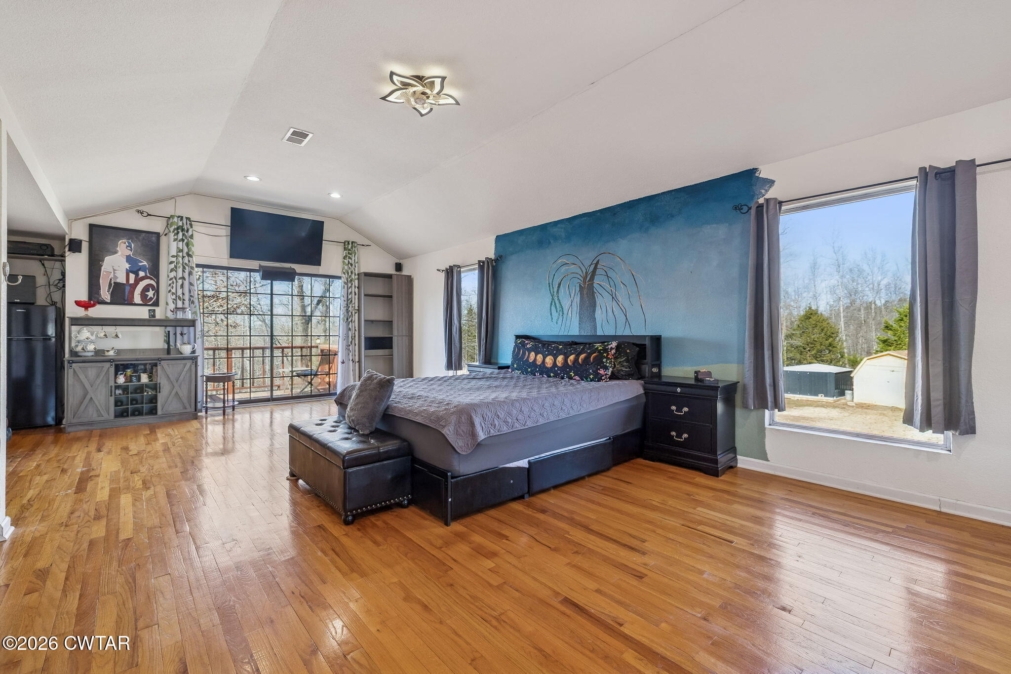 485 Lower Roans Creek Road Linden, TN 37096 - Photo 33 of 54 a spacious bedroom with a bed and wooden floor