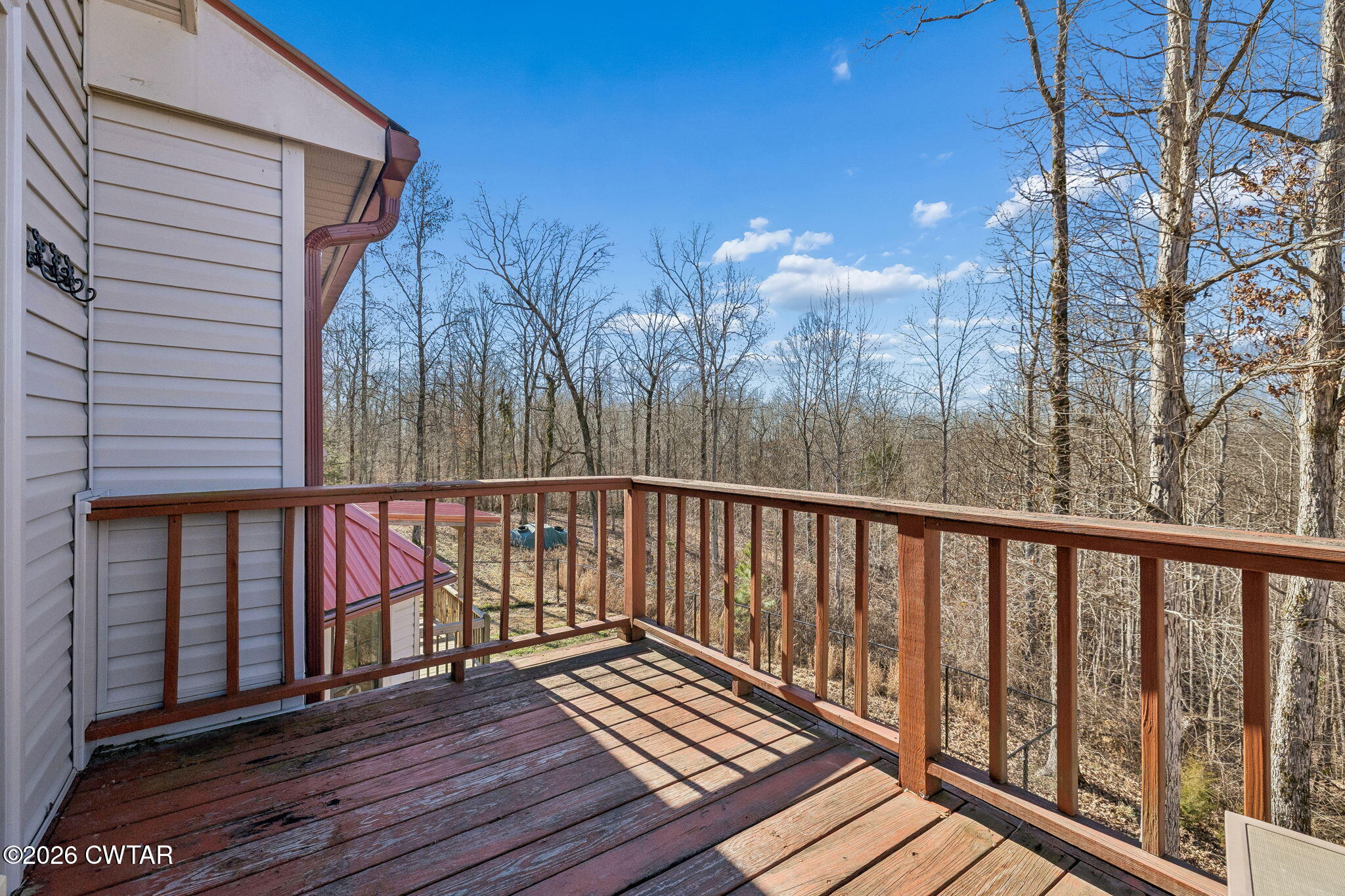 485 Lower Roans Creek Road Linden, TN 37096 - Photo 40 of 54 a balcony with wooden floor and outdoor space