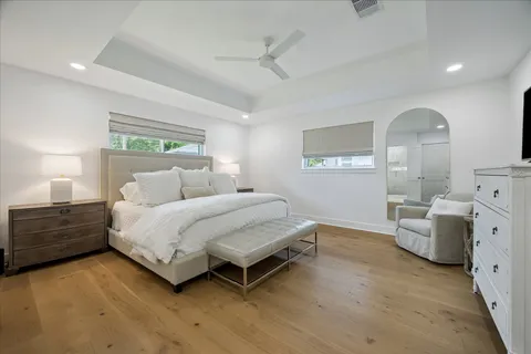 a spacious bedroom with a bed and a dresser