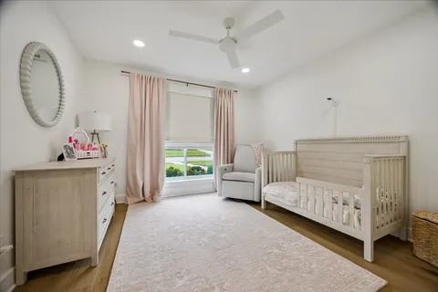 a bed room with a bed mirror and a window