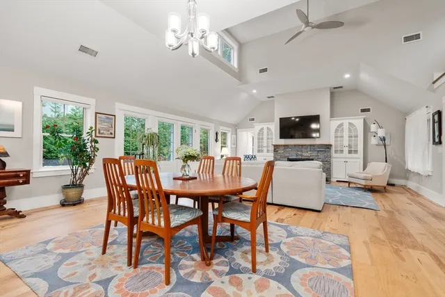 a dining room with furniture a chandelier and window
