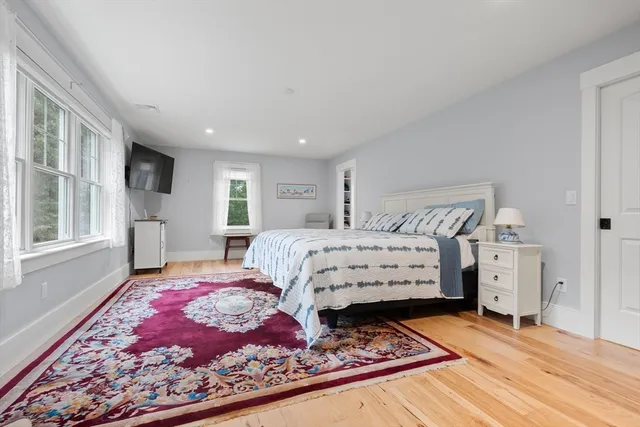 a bed sitting in a bedroom next to a window