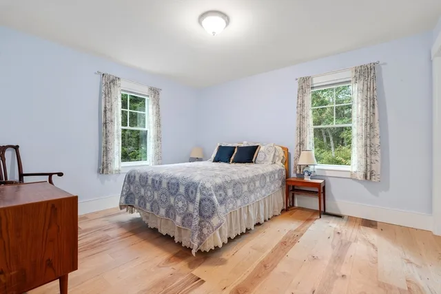 a spacious bathroom with a tub sink and mirror