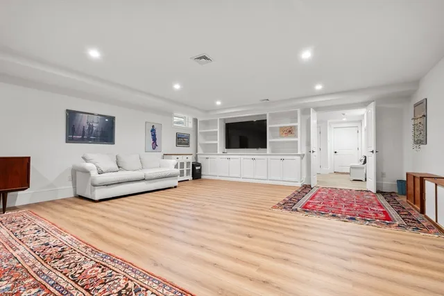 a view of a patio with table and chairs with wooden floor and fence