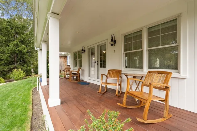 a living room with patio furniture and a potted plant