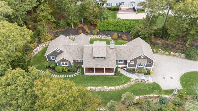 an aerial view of a house with swimming pool and garden