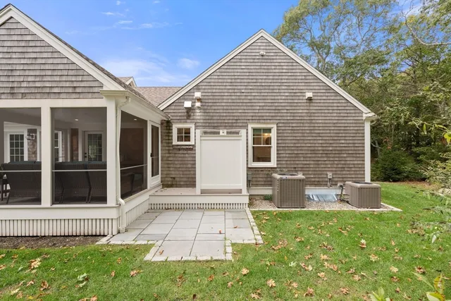 a view of a house with backyard and sitting area