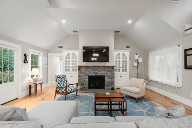 a living room with furniture a fireplace and a flat screen tv