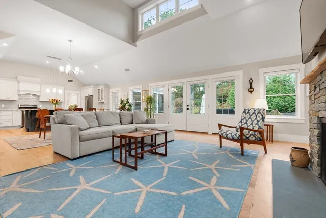 a living room with furniture and a dining table with kitchen view