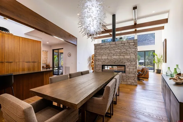 a dining room with furniture wooden floor a chandelier