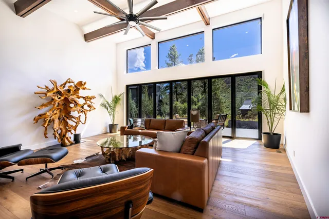 a living room with furniture and a floor to ceiling window