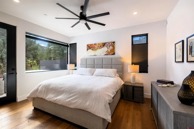 a bedroom with a large bed and a large window