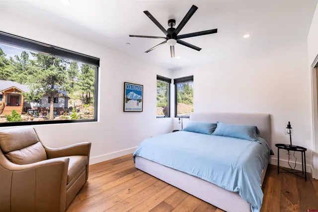 a bedroom with a large bed and a large window