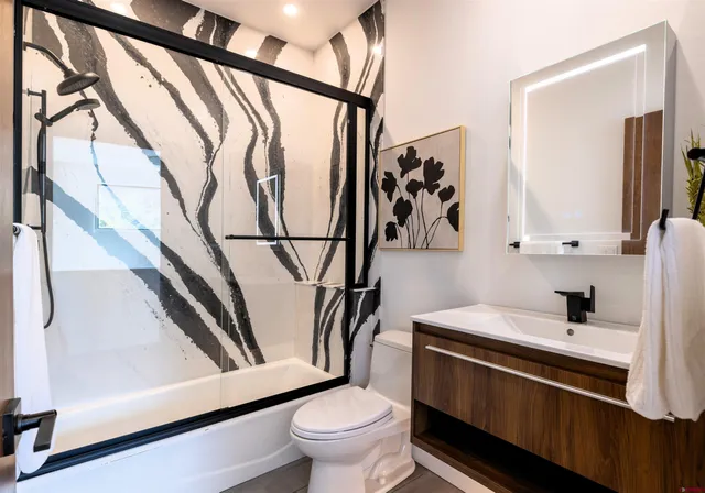 a bathroom with a toilet a sink and mirror