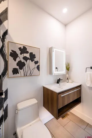 a bathroom with a sink mirror and toilet