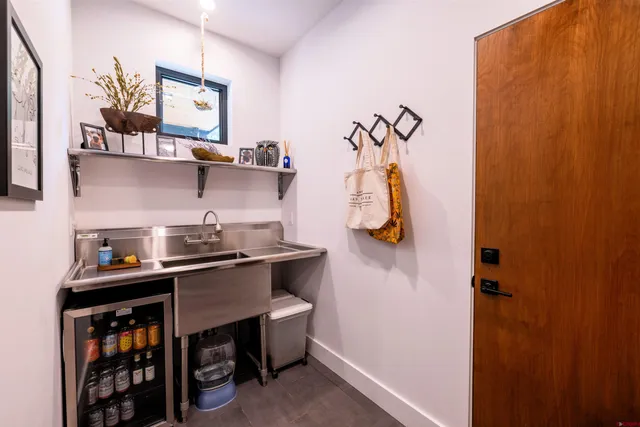 a kitchen with stainless steel appliances a sink a stove and a wooden floor
