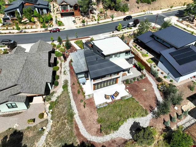 an aerial view of a house with a yard