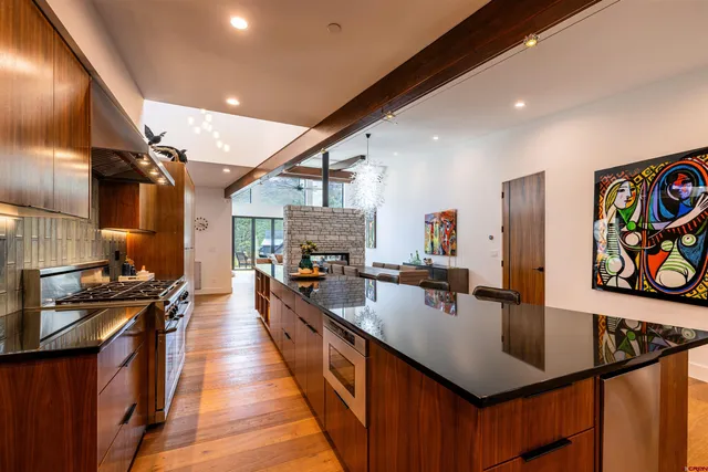 a kitchen with stainless steel appliances a sink stove and refrigerator
