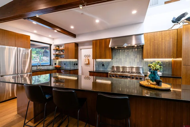 a kitchen with counter and chairs