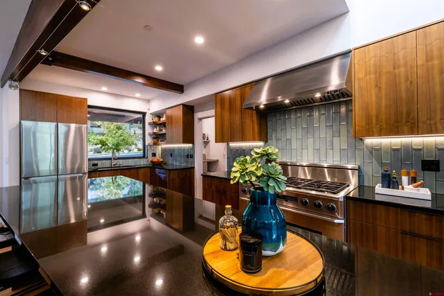 a kitchen with counter space dining table and chairs