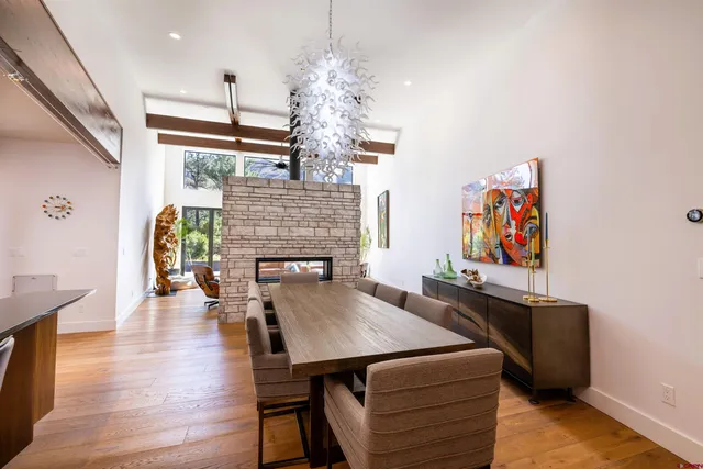 a view of a dining room with furniture wooden floor and chandelier