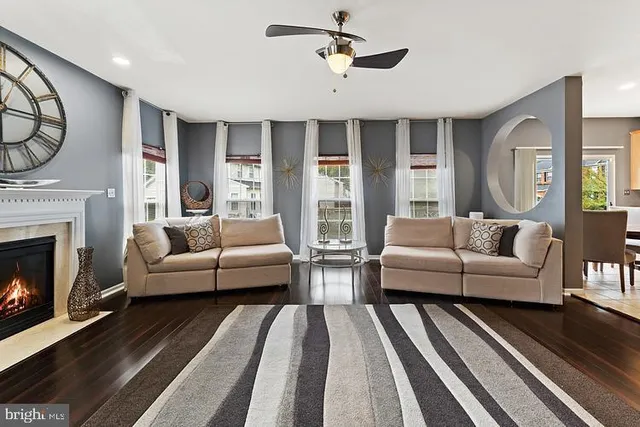 a living room with furniture a fireplace and a chandelier