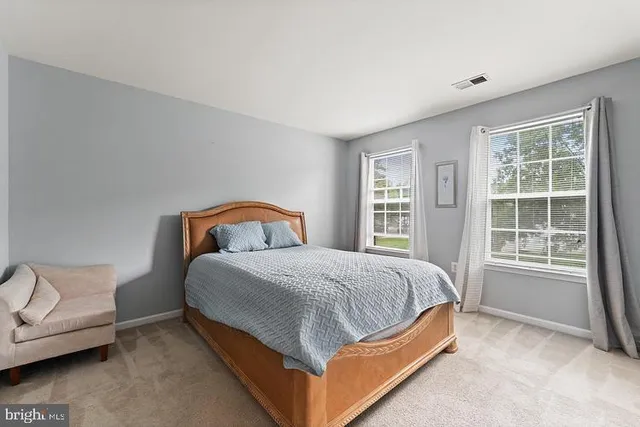 a bed sitting in a bedroom next to a window