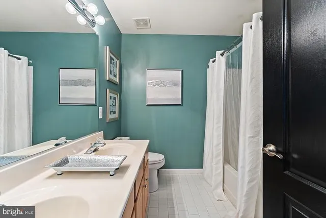 a bathroom with a sink a mirror and a toilet